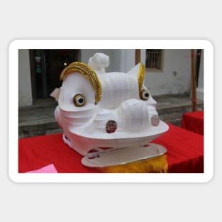 Unfinished white plastered Chinese Dragon mask on a festival Sticker